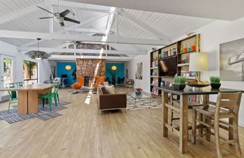 A living room with a wooden floor and a ceiling fan.